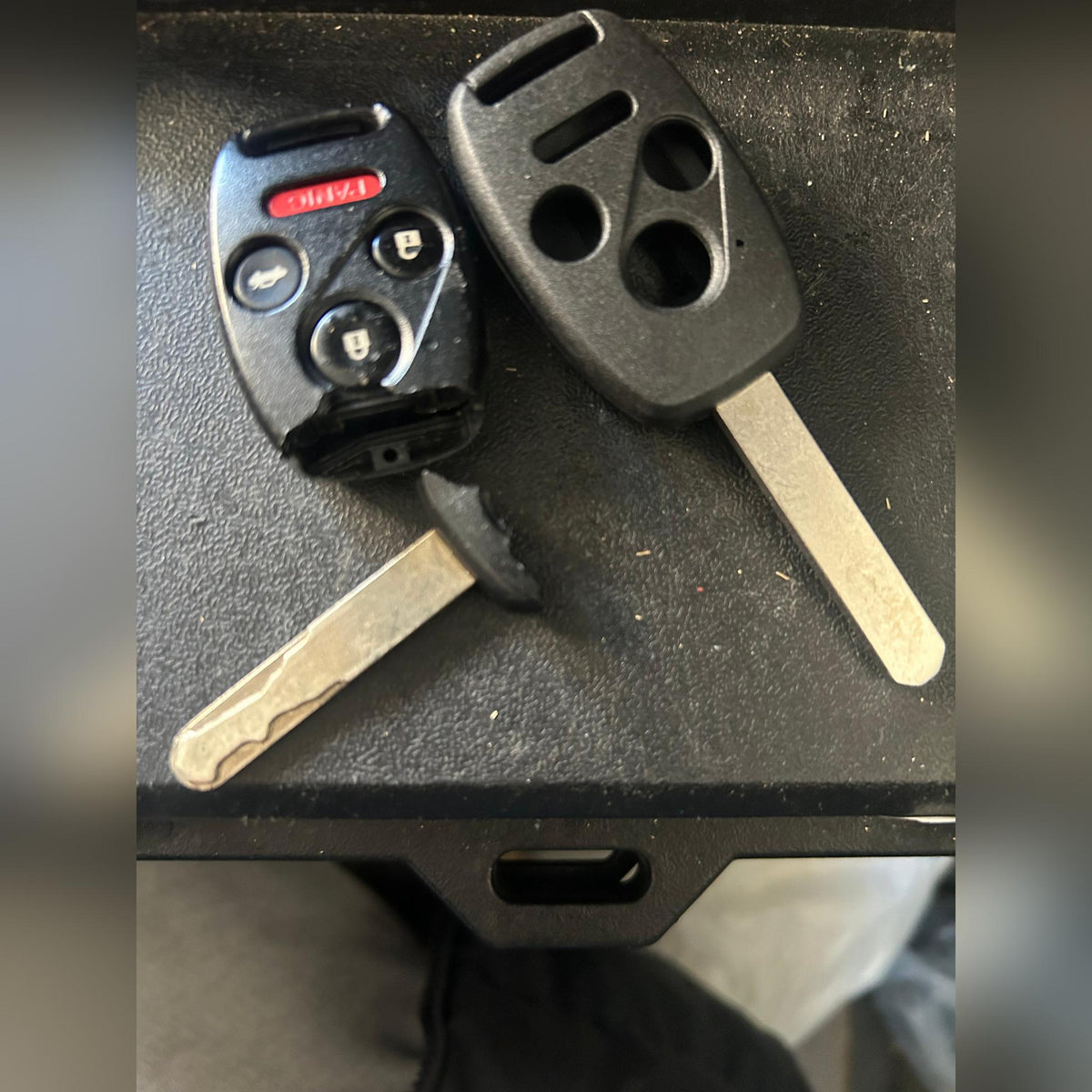 Worn Honda 3-button key next to a new replacement shell, before and after comparison