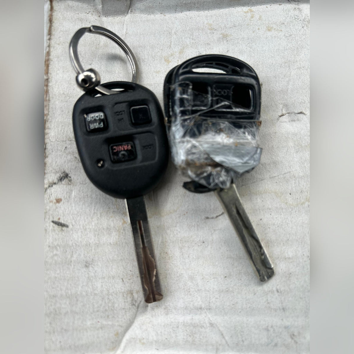 Worn Lexus key next to a new TOY48 replacement shell, before and after comparison